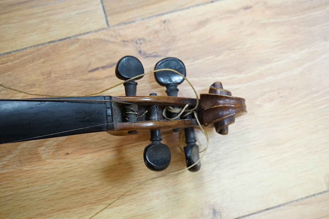 A quarter-size German violin, back measures 31cm. Condition - fair